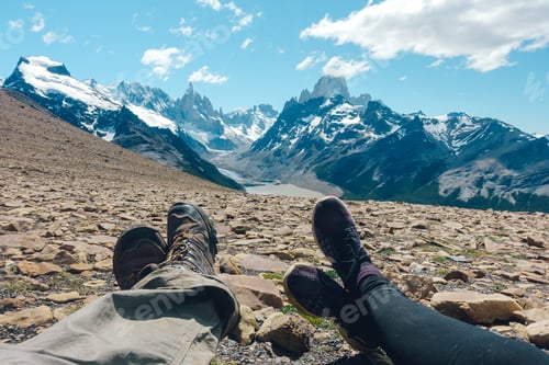 Preview: man and woman crossing his legs. beautiful view towards Cerro Torre