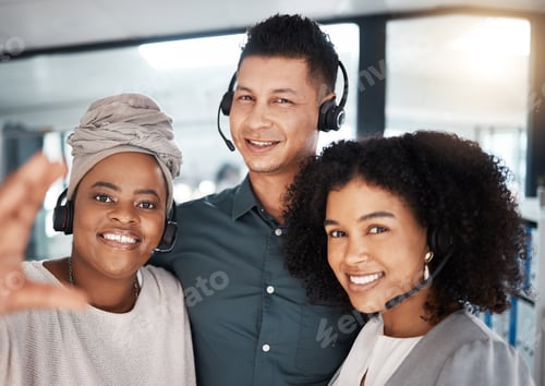 Preview: Portrait of a diverse group of happy smiling call centre telemarketing agents taking selfies togeth