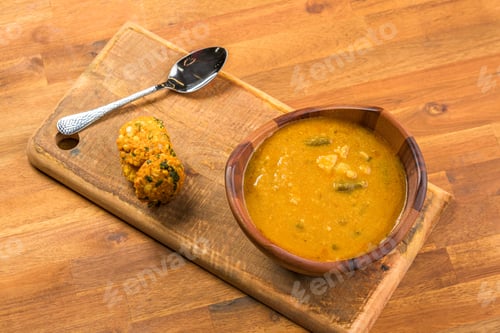 Preview: Top view of the bowl of delicious soup on a wooden board, Burmese food