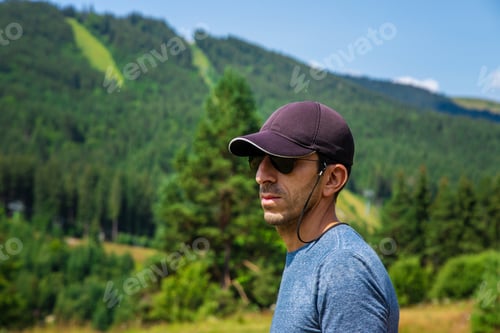 Preview: A man in the mountains looks. Selective focus. Selective focus.