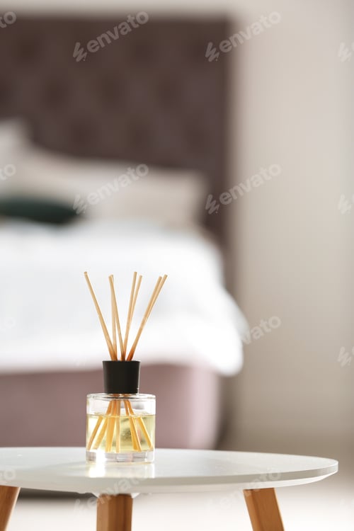 Preview: Aromatic reed air freshener on table against blurred background