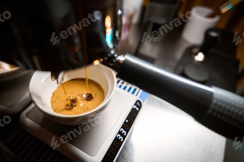 Preview: Barista pouring espresso from coffee machine
