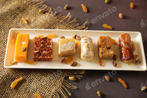 Preview: Top view of different pastry served on a white plate on a table