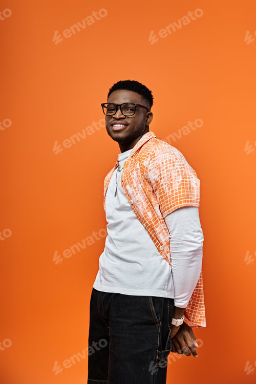 Preview: Vibrant Pose: Stylish Man in Orangest of Oranges