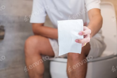 Preview: holding toilet paper roll during sit on toilet bowl