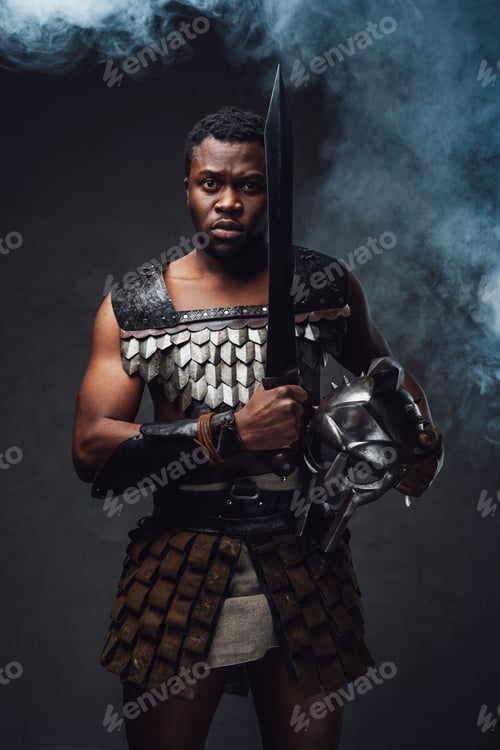Preview: Studio shot of fearful authentic gladiator of african descent with gladius