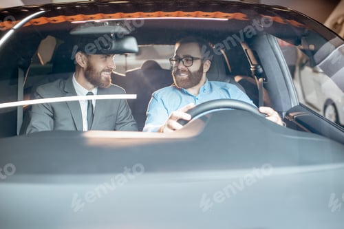 Preview: Sales manager with a client looking at the vehicle interior