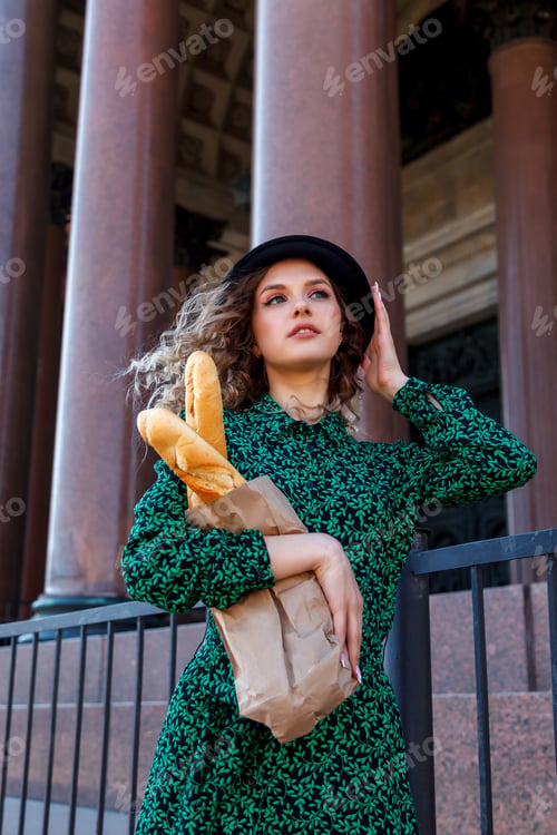 Preview: Portrait woman dressed in French style with baguette in hand