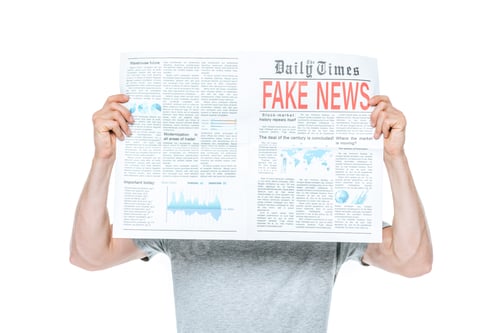 Preview: man reading newspaper with fake news, isolated on white