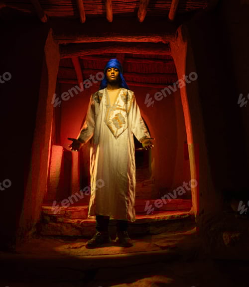 Preview: Berber Man in Traditional Djellaba Inside Ancient Mud-Brick Kasbah Doorway