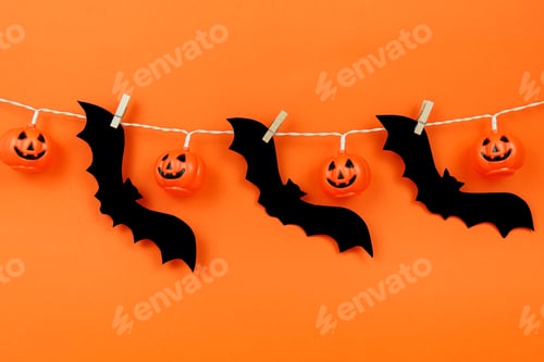 Preview: Orange background with halloween decorations. Scary pumpkins.