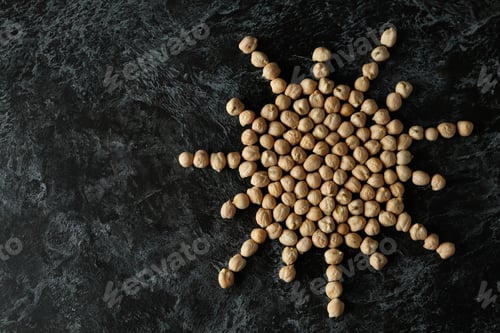 Preview: Sun made of chickpea on black textured background