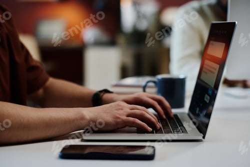 Preview: Businessman typing on laptop keyboard