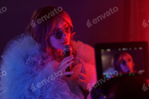 Preview: Young Woman Holding Microphone during Music Video Shoot