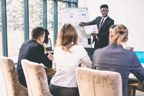 Preview: Business team talking to african-american man at work discussion. Young Afro American Man standing