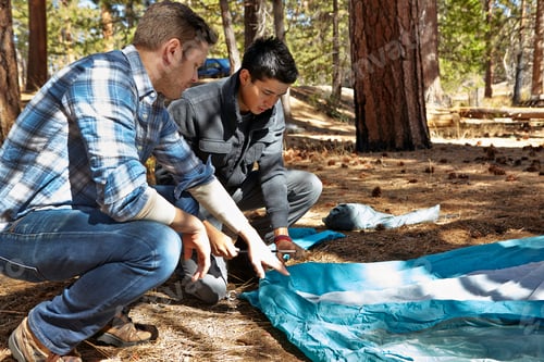 Preview: Two young men preparing to camp in forest, Los Angeles, California, USA