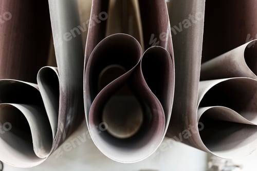 Preview: Closeup of sanding belts ready to be used in a wood working shop.