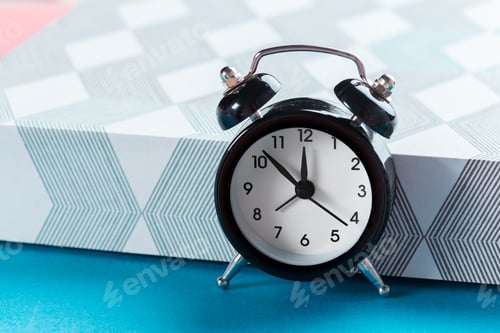 Preview: Vintage background with retro alarm clock on table