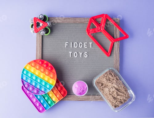 Preview: Colorful fidget toys to help reduce stress and anxiety in kids on purple with letter board