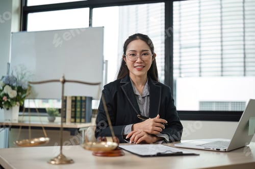 Preview: Professional Female Lawyer Reviewing Legal Documents in Modern Office Setting for Lawsuit