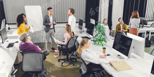 Preview: high angle view of professional young multiracial businesspeople working together in open space