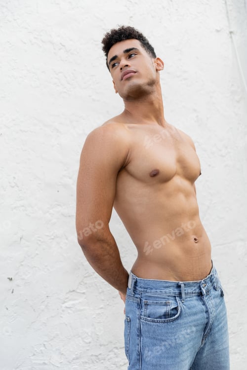 Preview: Young and sexy cuban man with athletic body standing near while wall in Miami, south beach