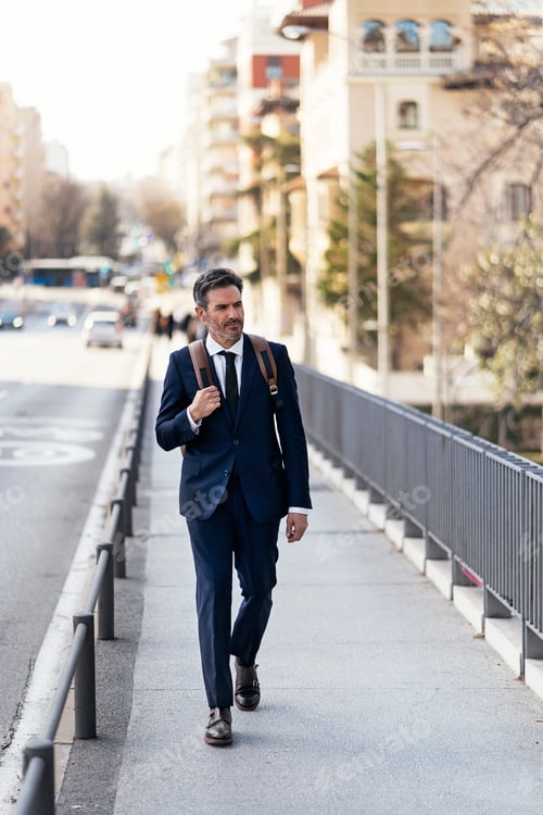 Preview: Businessman walking in city