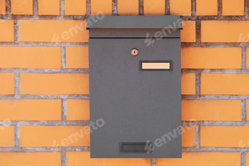 Preview: Black metal letter box on red brick wall