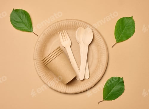 Preview: Paper cups, wooden spoons and forks on a beige background