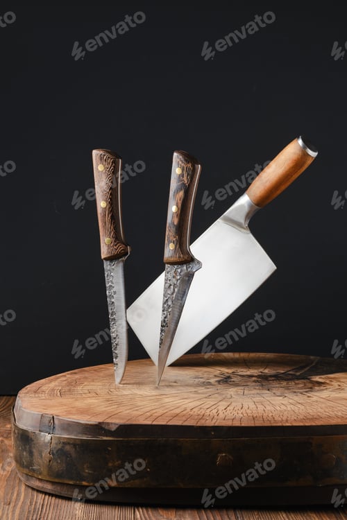 Preview: Cleaver and knives stick out of wooden blockhead