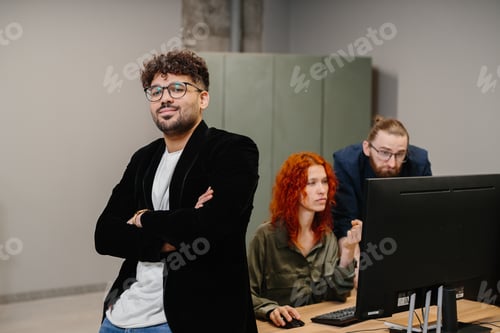 Preview: Confident business leader smiling with team working