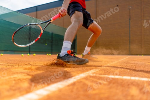 Preview: close-up of a tennis player's or instructor's foot on an outdoor court ground dust rising