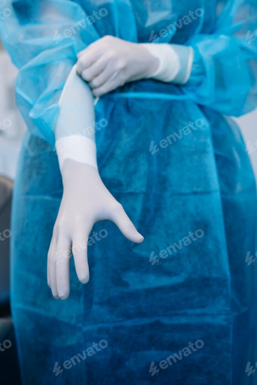 Preview: Medical Professional in Surgical Gown Preparing for Surgery