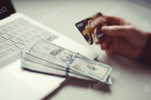 Preview: Millennial candid authentic man using laptop and credit card for e-commerce business at home