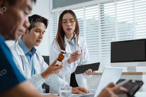 Preview: Healthcare team reviews patient info, medication, and health progress on charts.