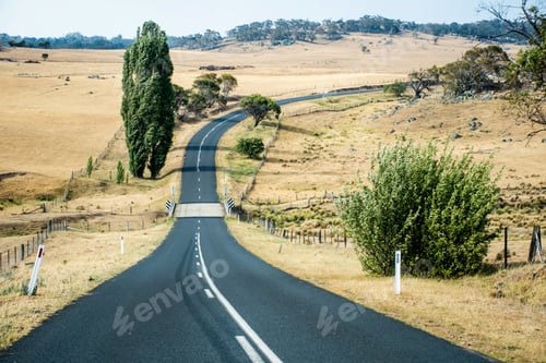 Preview: Open empty road surrounded by fields and farms. Causeway bridge