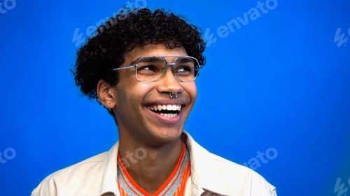 Preview: Happy young african american man looking away isolated on blue
