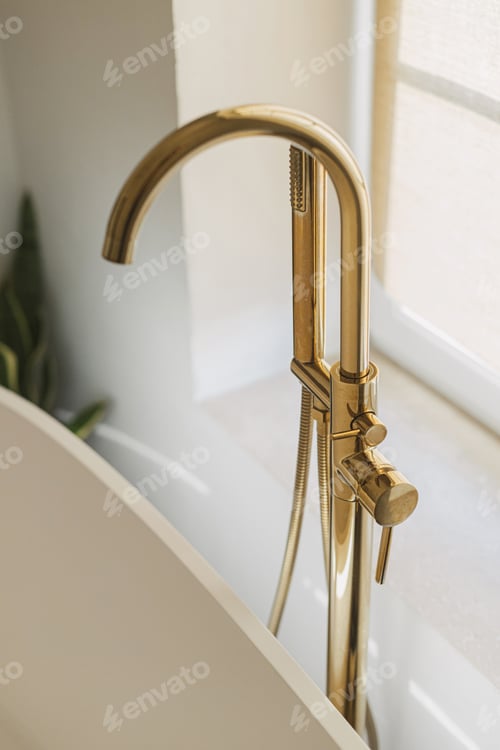 Preview: Modern gold faucet from floor and bathtub at big window, modern boho bathroom design