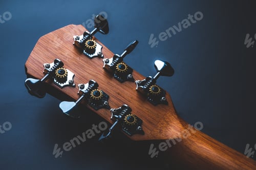 Preview: Acoustic guitar, music instrument resting against a dark black background with copy space