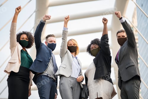 Preview: Successful business people in mask during covid 19 pandemin