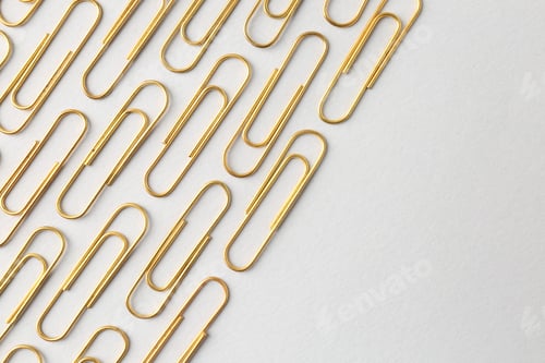 Preview: Golden paper clips on light background, flat lay. Space for text