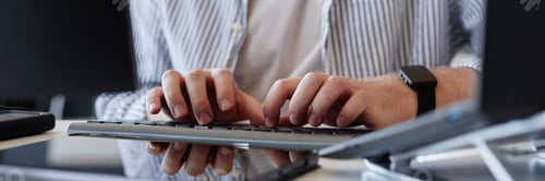 Preview: Typing on Keyboard with Reflections and Devices Visible