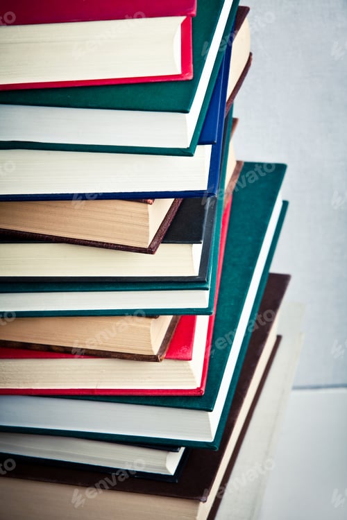 Preview: Very high stack of books on a table