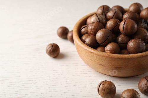 Preview: Bowl with organic Macadamia nuts on white table