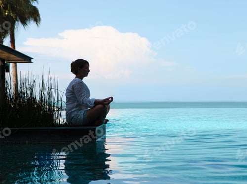 Preview: Silhouette of attractive woman sitting in meditating position