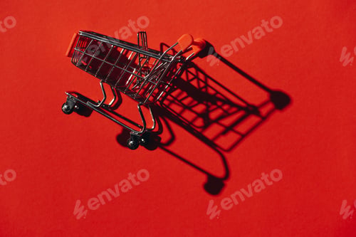 Preview: one shopping cart with shadow on red wall