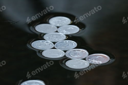 Preview: Closeup of coins on a black soft surface