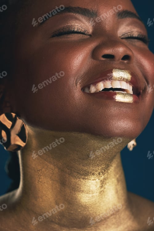 Preview: Smile, gold and makeup with face of black woman in studio for creative, luxury and cosmetics. Glow,