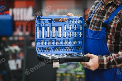 Preview: Mechanic holding professional tool kit in auto parts store