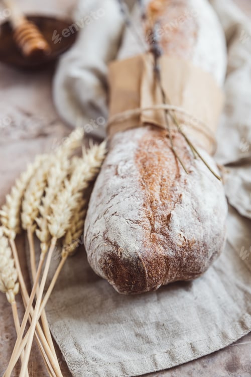 Preview: Loaf of artisan sourdough bread with lavender and honey with wheat ears Traditional artisan bread.